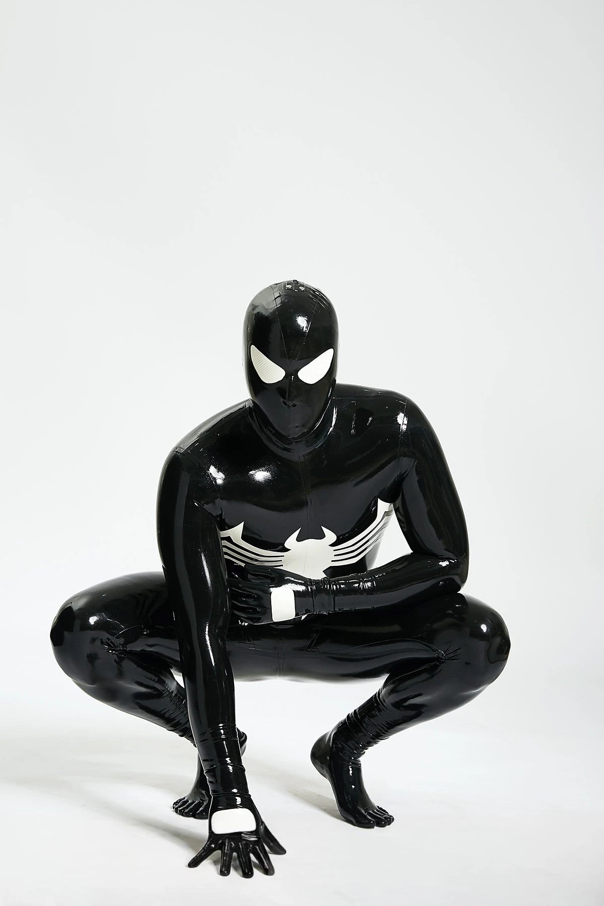Black, trim color is Pure White Male 'Spermaphora' Latex Catsuit