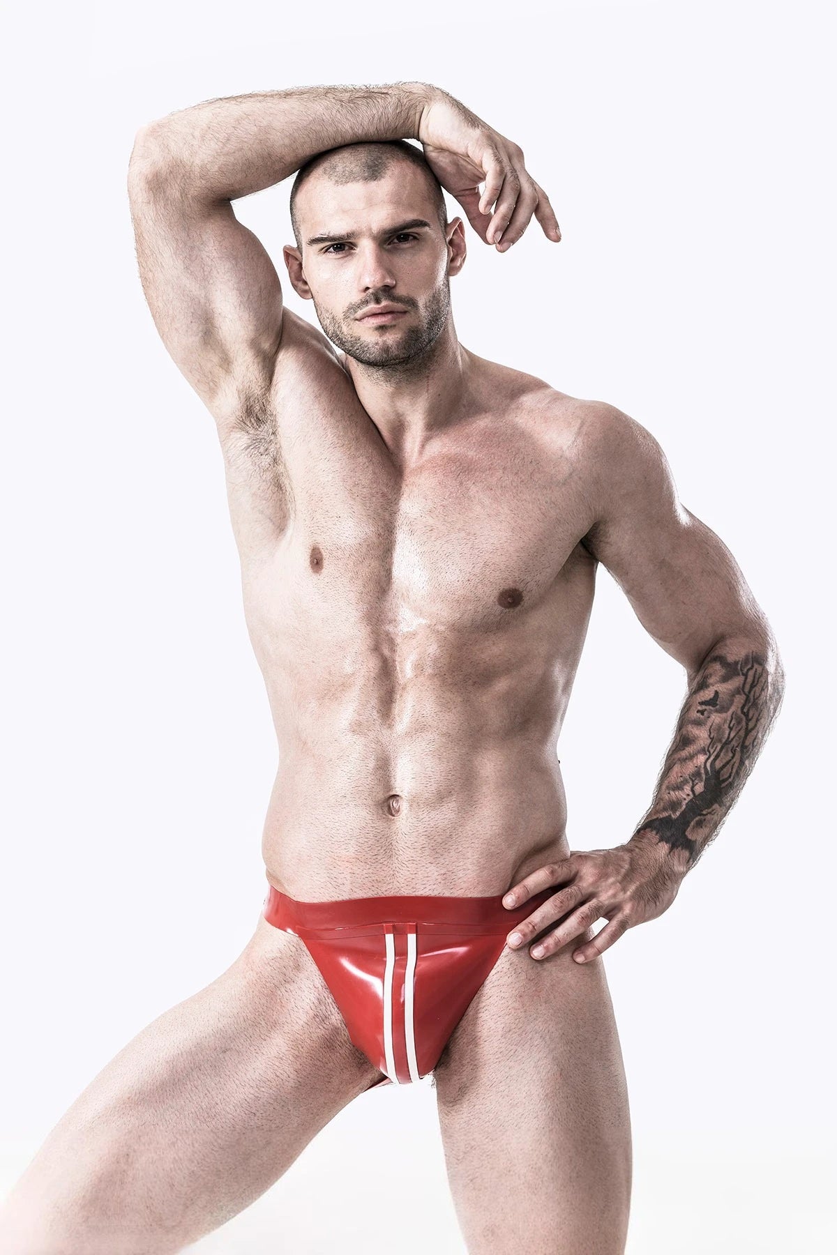 Red, secondary color is White Male Latex Double Line Jockstrap