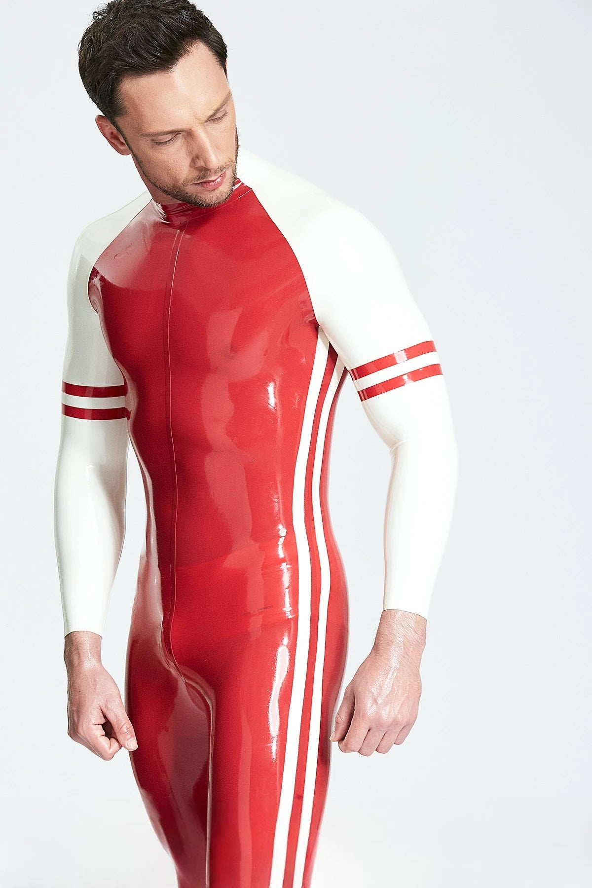 Red, trim color is White. Male 'Blaze' Raglan-Sleeved Latex Catsuit